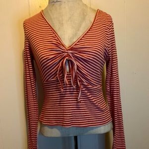 Striped long-sleeve red and white shirt.